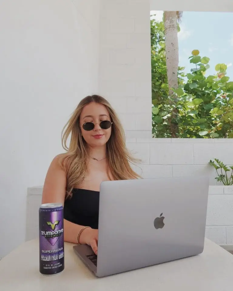 image of student on computer with trumpdrive energy drink